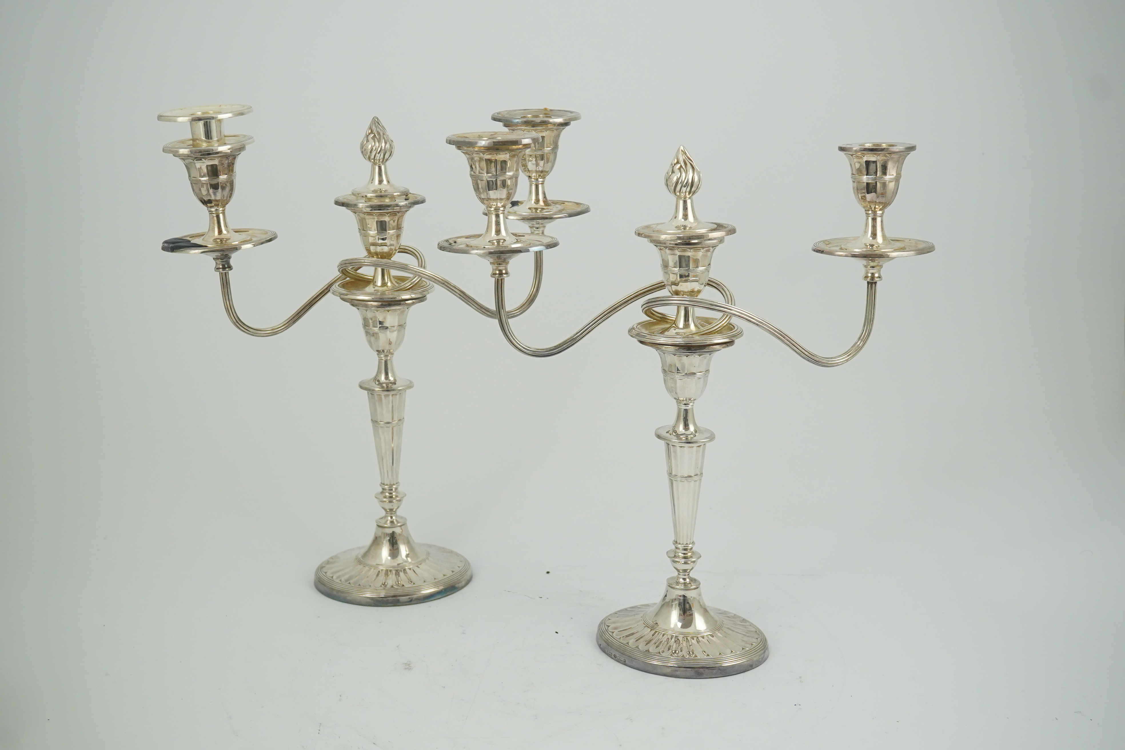 A modern pair of silver two branch three light oval candelabra, by James Dixon and Sons Ltd